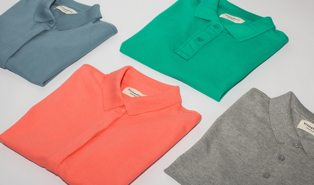 Four neatly folded polo shirts.